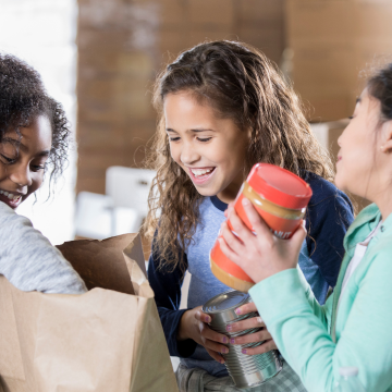 Three girls at a food bank event.