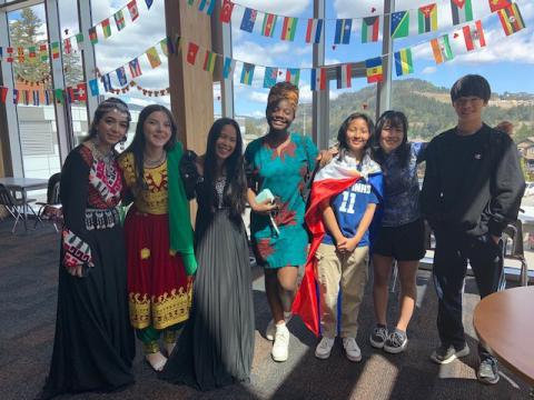 A group of students with some wearing their respective cultural outfits