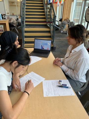 Three students are working at a table