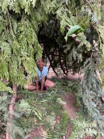 Student in the forest. Lessons taught in the forest bring students closer to nature and promote Land Based Learning