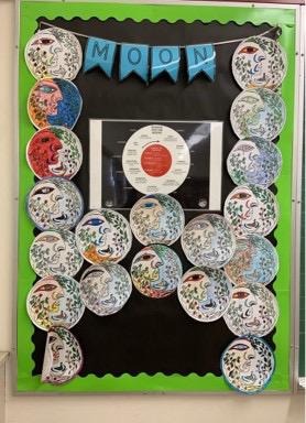 A bulletin board of student work about the moon