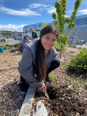Goal 1 - RBSS student working in our beautiful and growing garden.